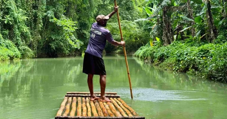 Raft captain guiding a bamboo raft down the Martha Brae River in Jamaica