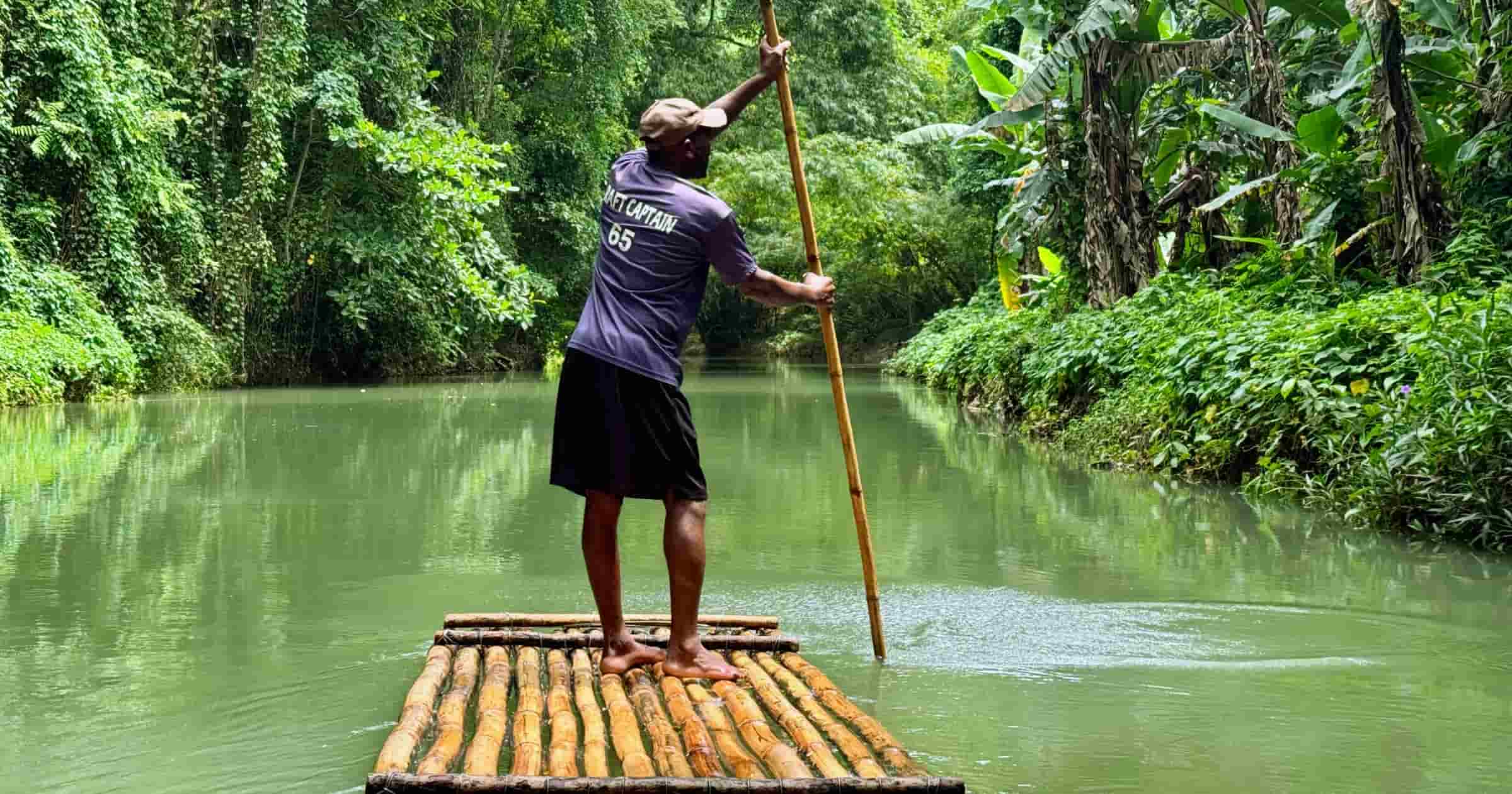 Raft captain guiding a bamboo raft down the Martha Brae River in Jamaica