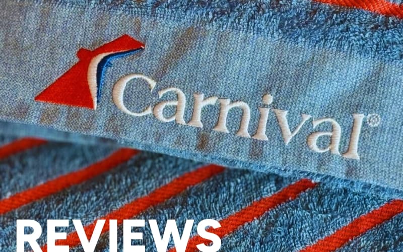 Carnival-branded blue towel with logo, representing cruise reviews.