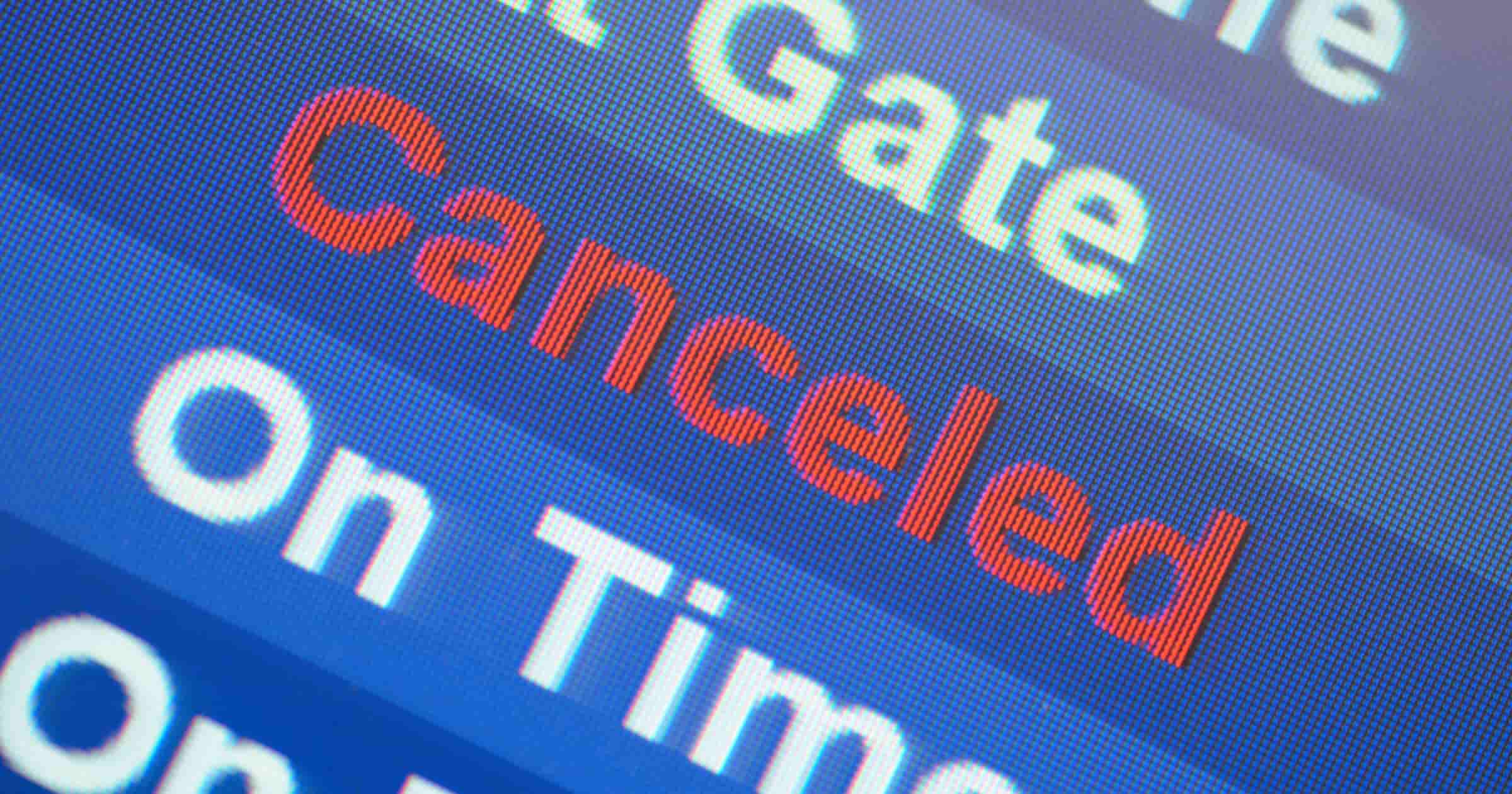 Airport departures board showing flight status marked “Canceled.”